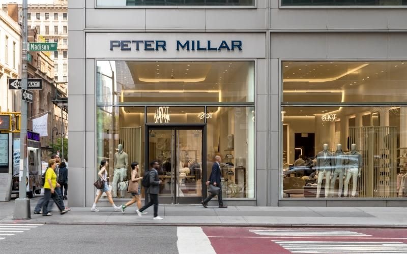 people walking past a store