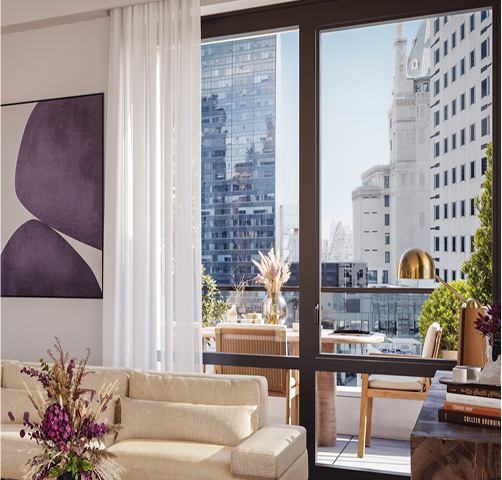 large floor to ceiling window in full floor Manhattan penthouse apartment with private balcony in the background